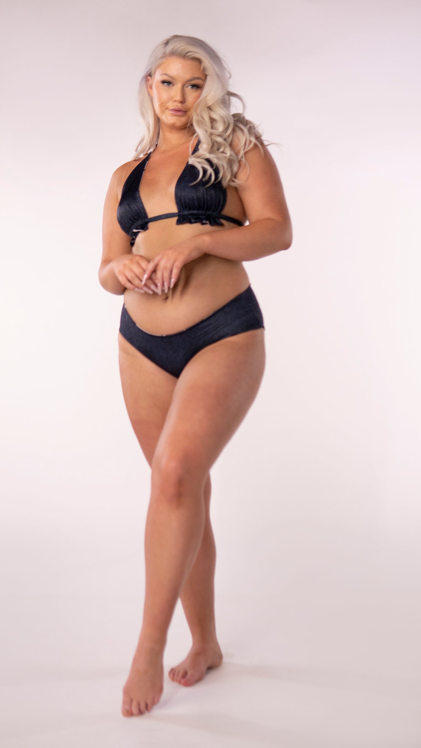 A staple bikini top, the classic triangle cut is always in fashion. This updated style features a ruffle detail under the bust where the tie gathers the fabric. This style features a wide cut under bust strap for additional comfort and support.