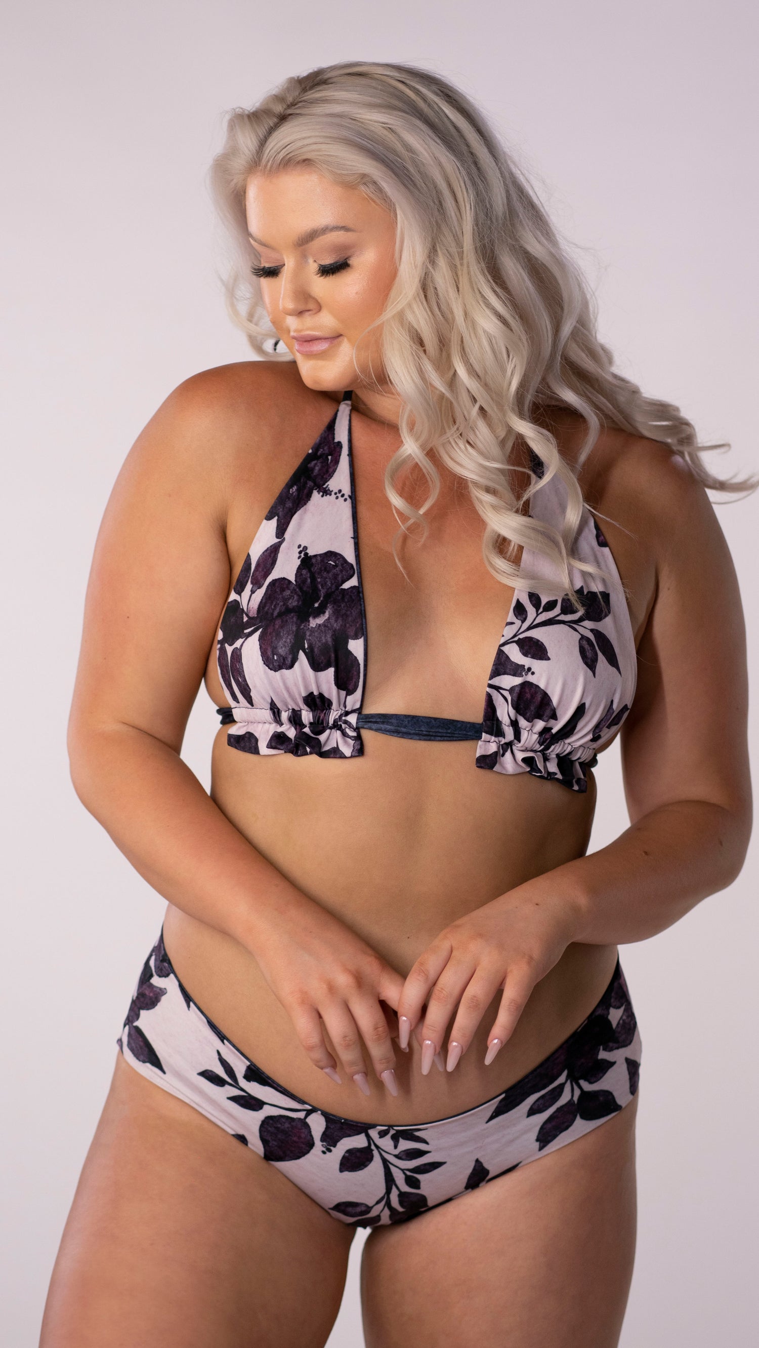 A staple bikini top, the classic triangle cut is always in fashion. This updated style features a ruffle detail under the bust where the tie gathers the fabric. This style features a wide cut under bust strap for additional comfort and support.