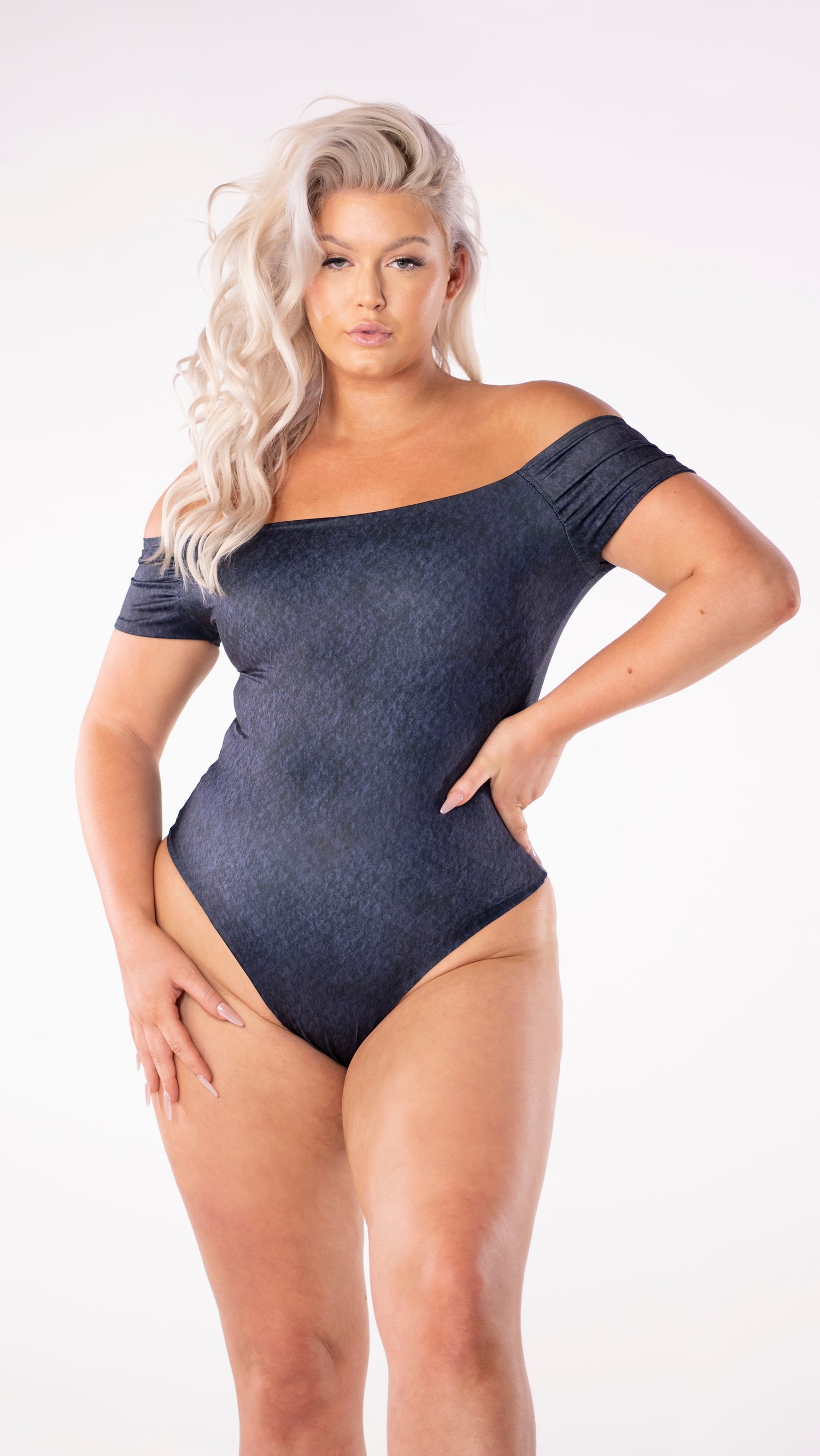 A reversible off-the-shoulder one piece that is both sexy and stylish; a solid navy blue watercolour wash on one side and a pink and navy watercolour hibiscus floral print on the other. The back features a sexy cut away open back detail to add allure. The suit offers full bottom coverage and a high leg line to bring the height of both comfort and sophistication.